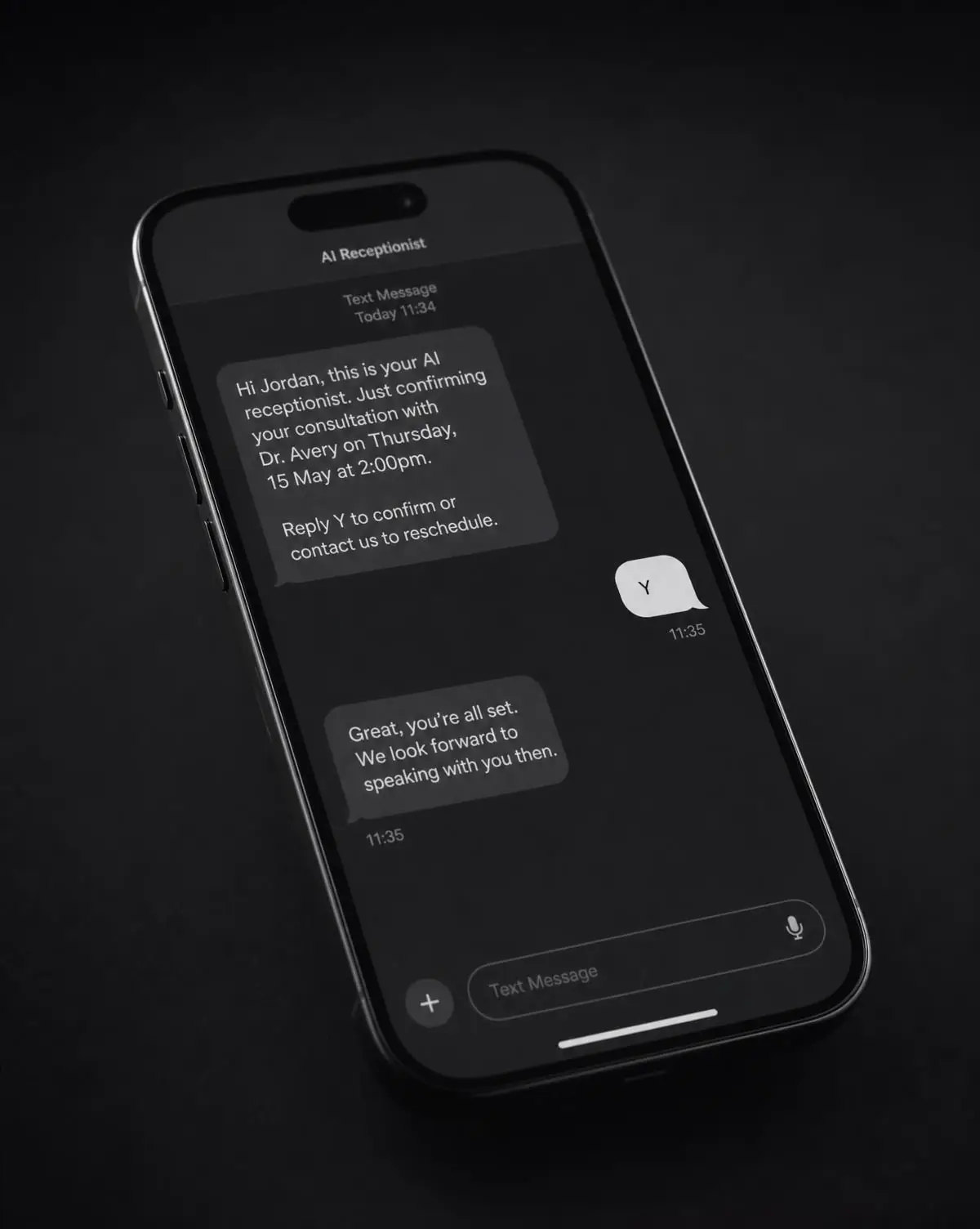 A smartphone on a matte black surface showing a minimal text conversation in which a consultation has been booked.